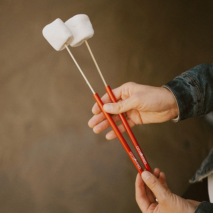 Four red reusable skewers with white foam tips for grilling and roasting