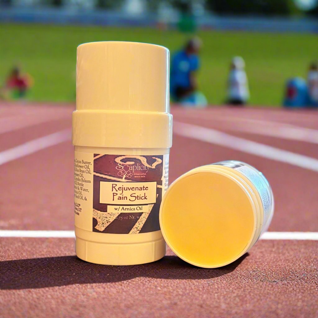 Yellow pain relief balm stick with white cap, open with yellow balm exposed