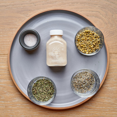Small Organic Pharmere Relax bottle with dried botanical blends in four bowls on tray.