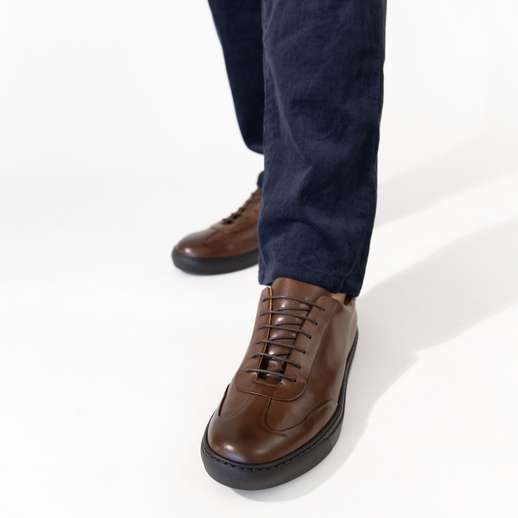Brown leather lace-up oxford shoes with dark jeans