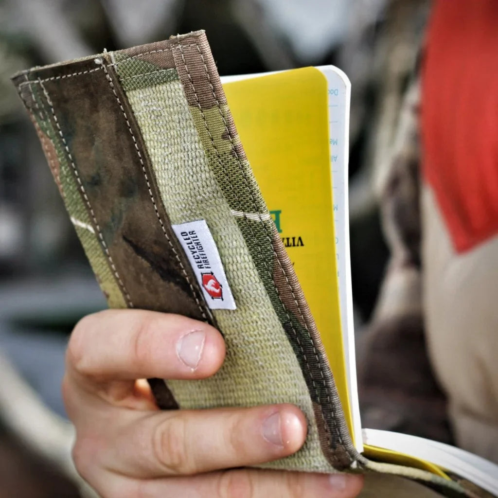 Firehose notebook cover open, showing elastic strap and notebook sleeve