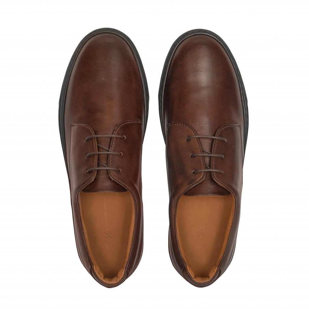 Pair of men's brown lace-up oxford shoes, tan interior and dark rubber soles