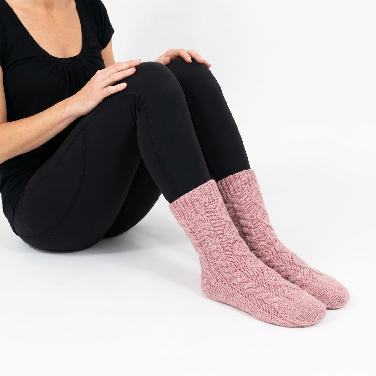 Rose pink slipper socks with diamond cable pattern and white sherpa top