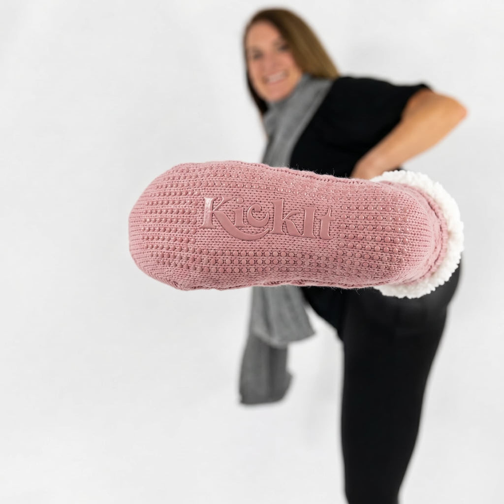Rose pink slipper socks with white sherpa cuff and "Kickit" logo knit