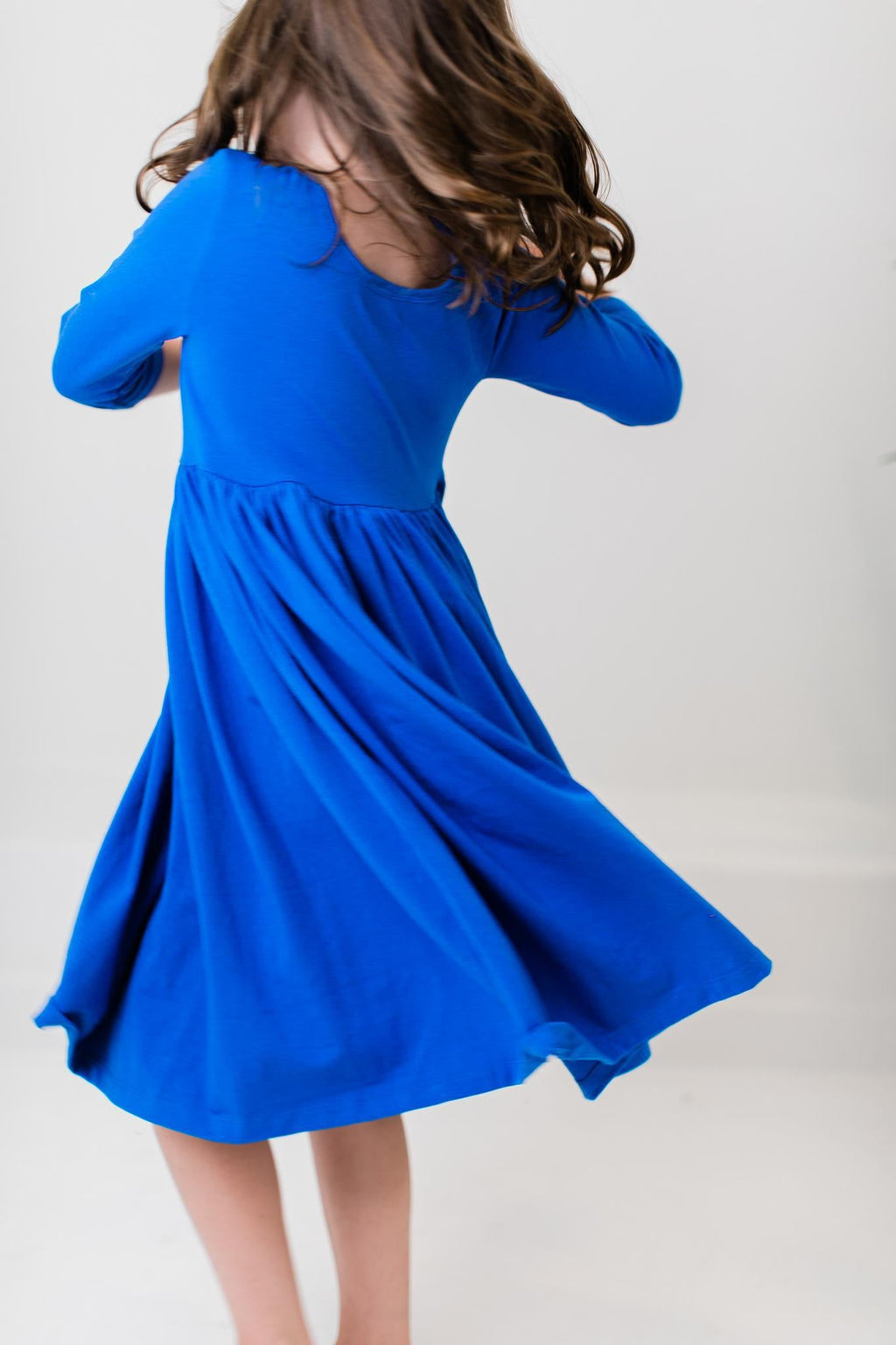 Royal blue twirl dress with 3/4 sleeves and gathered skirt hem
