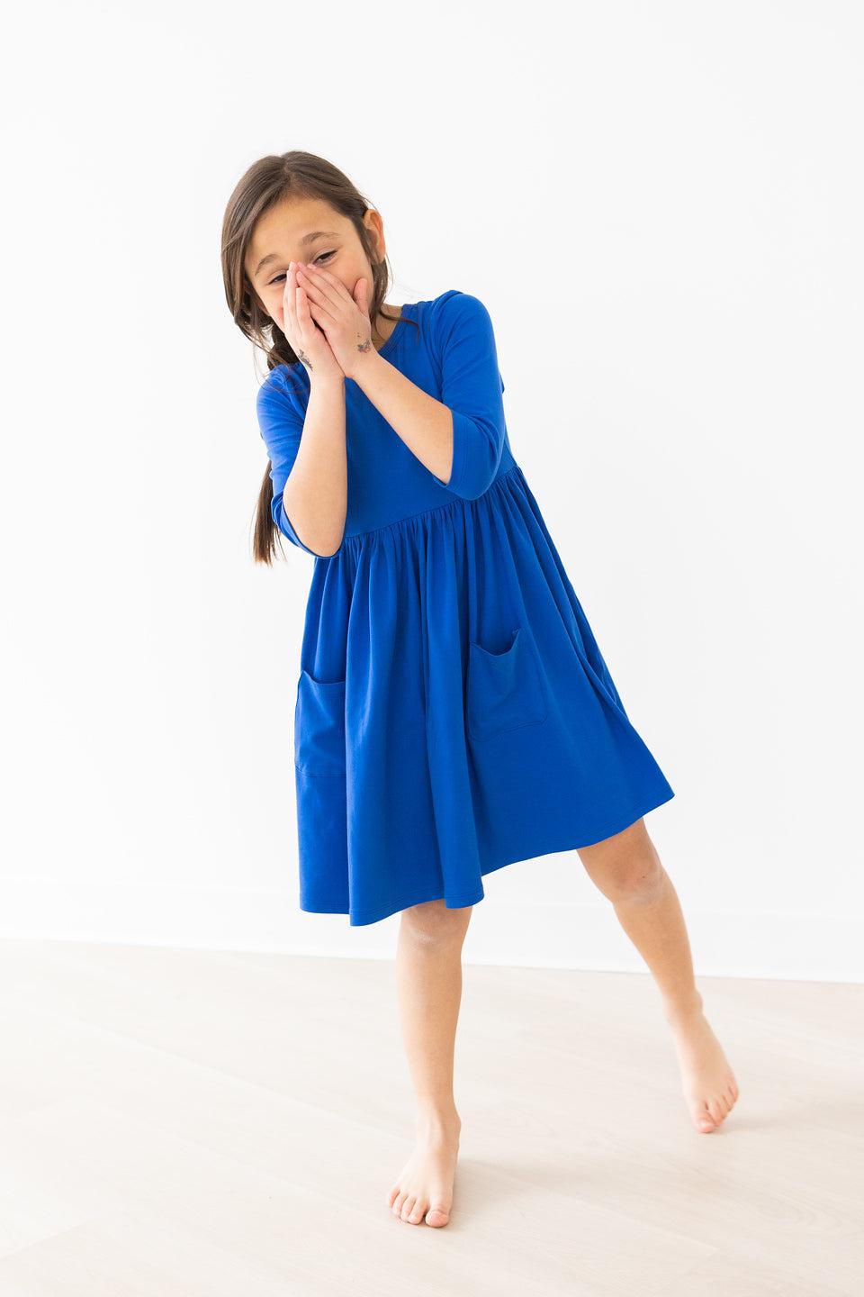 Royal blue pocket twirl dress with 3/4 sleeves, gathered skirt, and side pockets