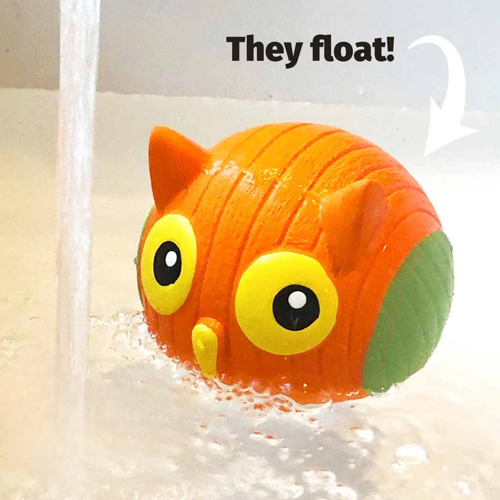 Orange and green latex dog ball toy floating in water