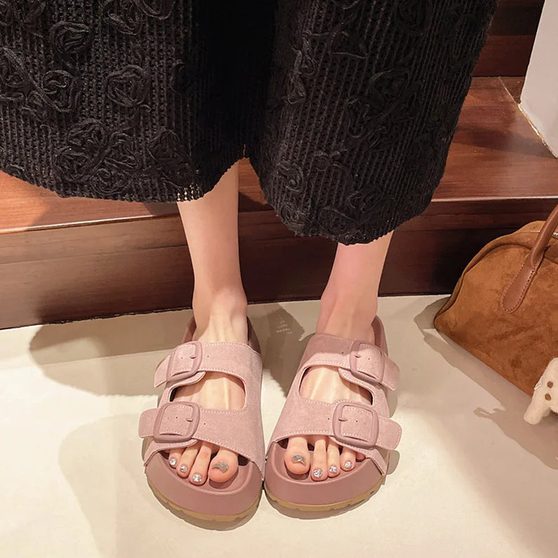Pink suede platform slide sandals with two adjustable buckle straps