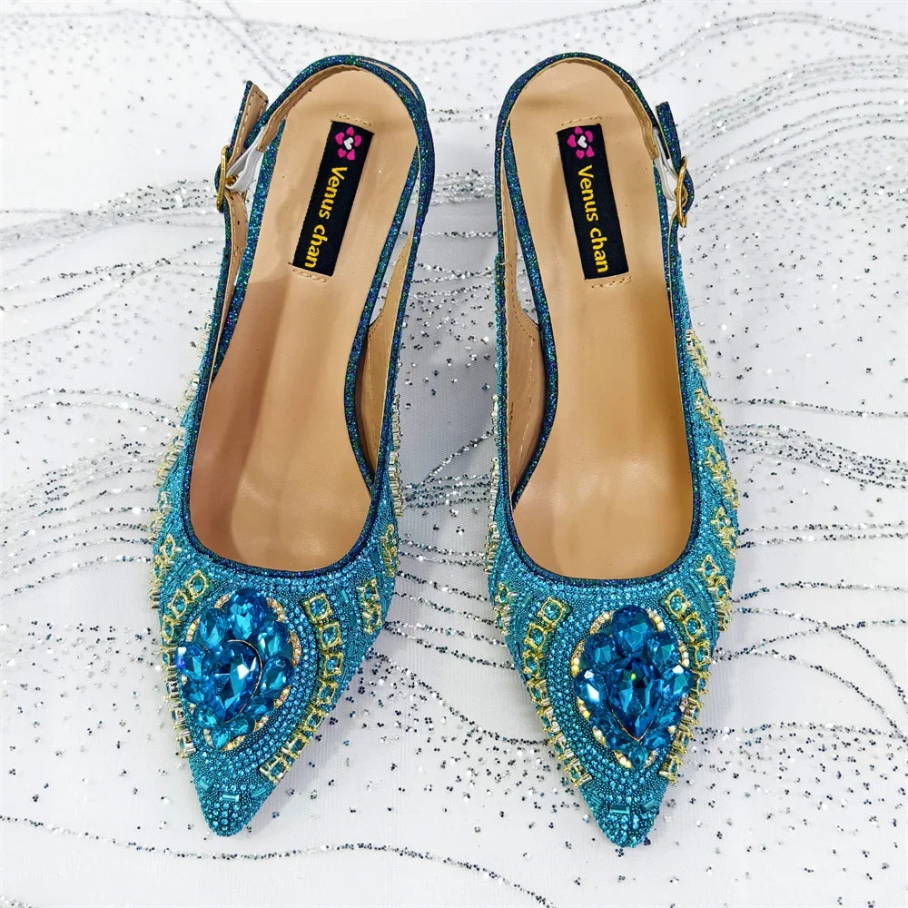 Blue rhinestone pointed-toe slingback heels pair with matching beaded bag