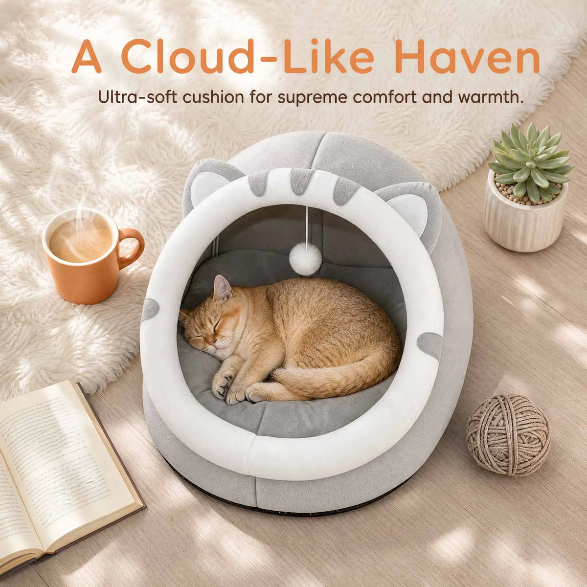 Gray covered cat bed cave tent with resting cat inside, white opening ring and pom-pom