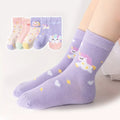 Kids mid-calf socks in lavender with unicorn and star designs, worn on a leg.