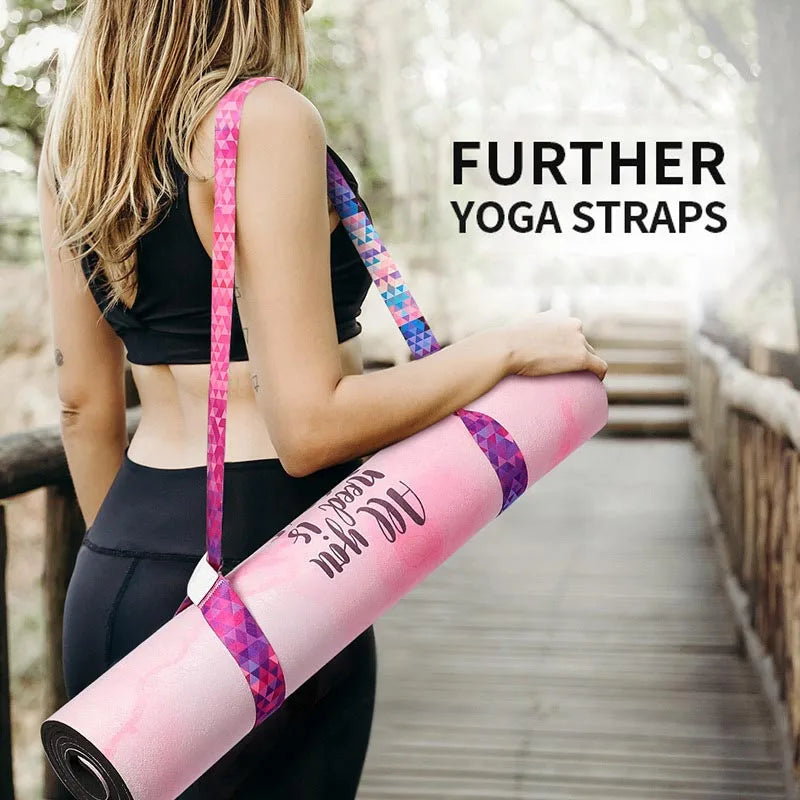 Pink-and-blue patterned yoga mat shoulder strap on a rolled yoga mat