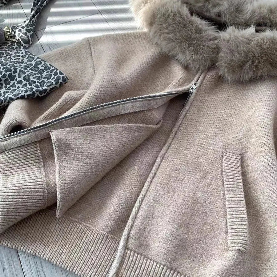 Khaki sweater jacket detail showing front zipper and ribbed knit cuffs