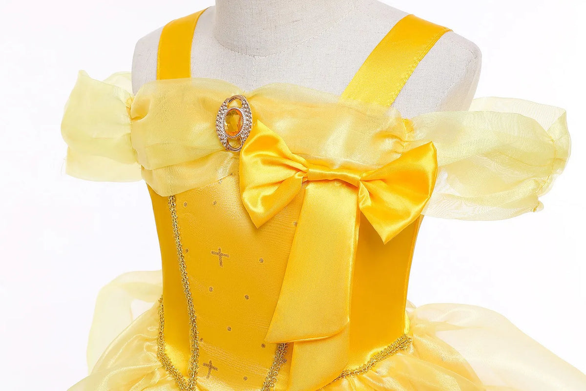 Yellow satin princess dress bodice with ribbon bow, heart-shaped charm detail, and tulle layers