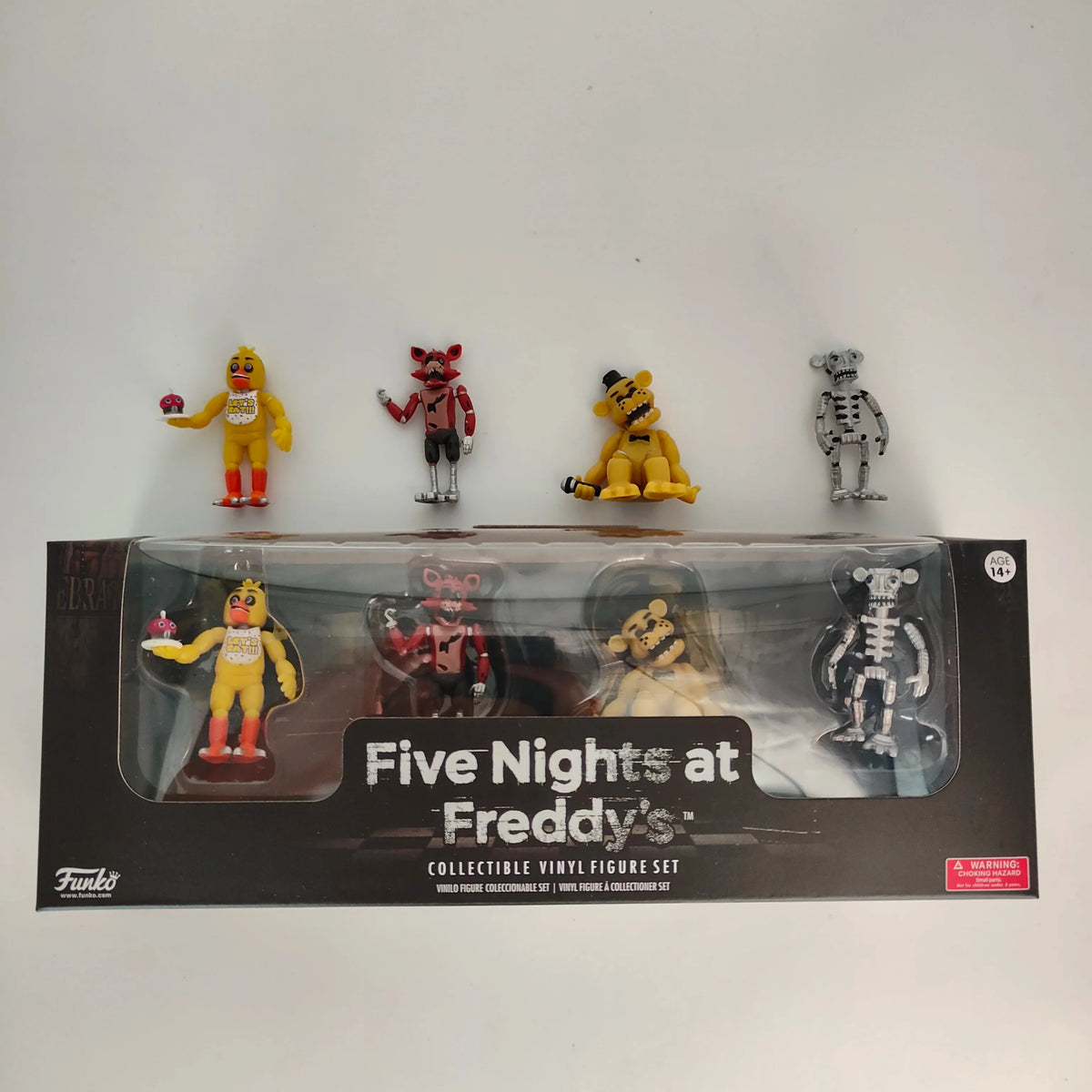 Window-box collectible vinyl action figure set showing four characters above the box