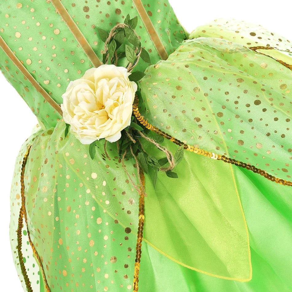 Green fairy princess dress close-up: dotted bodice, cream flower detail, ribbon trim