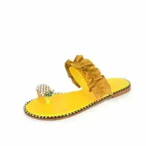Yellow flat slide sandals with pearl pineapple charm and tall ruffle strap