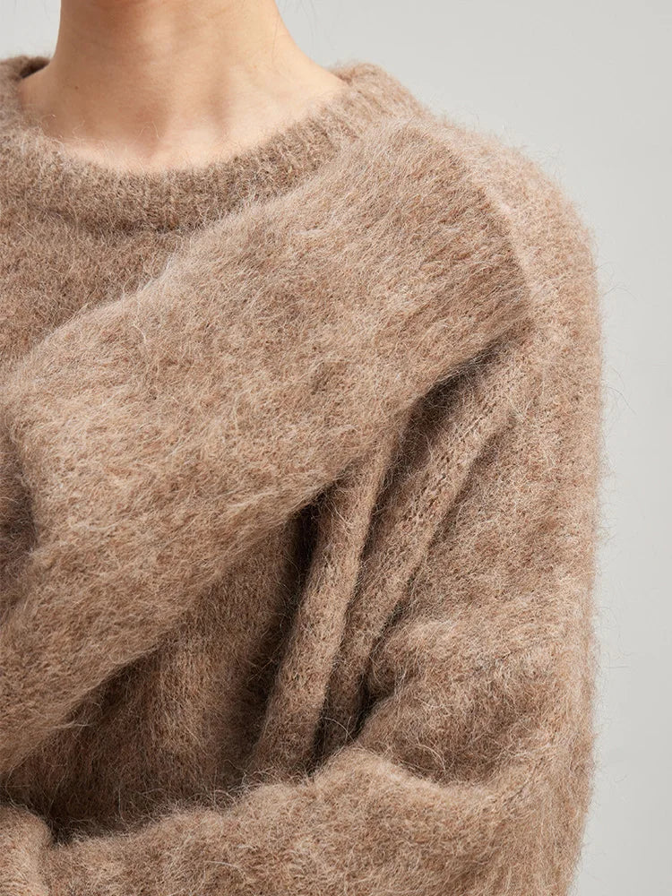 Women’s alpaca pullover sweater close-up in light camel, ribbed crew neck, fuzzy knit texture