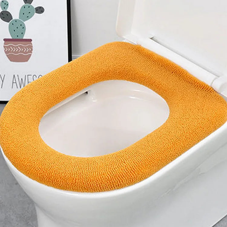 Orange plush toilet seat cover mat with center opening, soft looped terry.