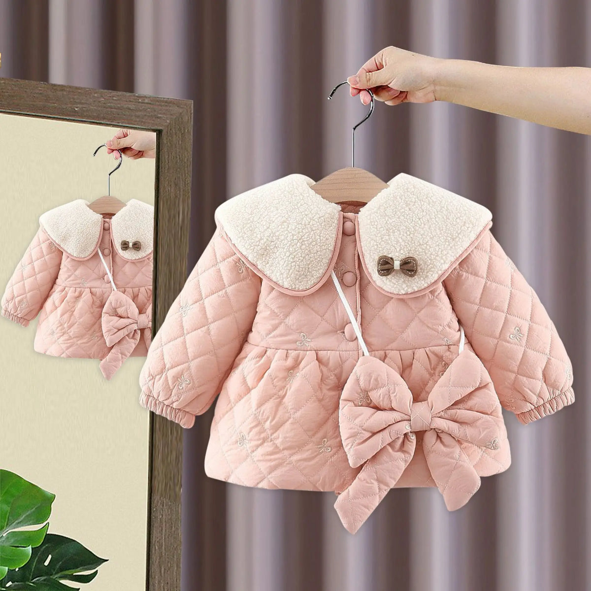 Light pink quilted baby jacket with large bow at hem and soft hood collar