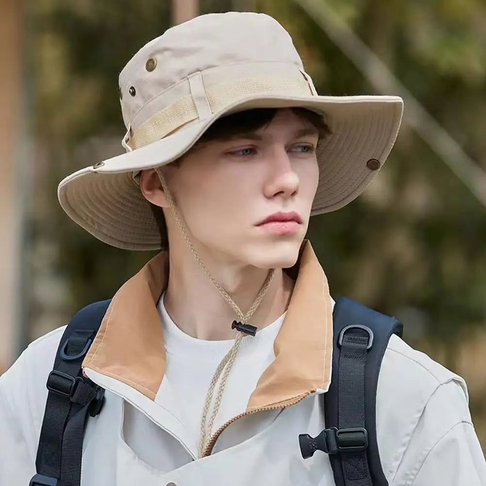 Light khaki wide-brim bucket hat with chin cord and eyelets, worn