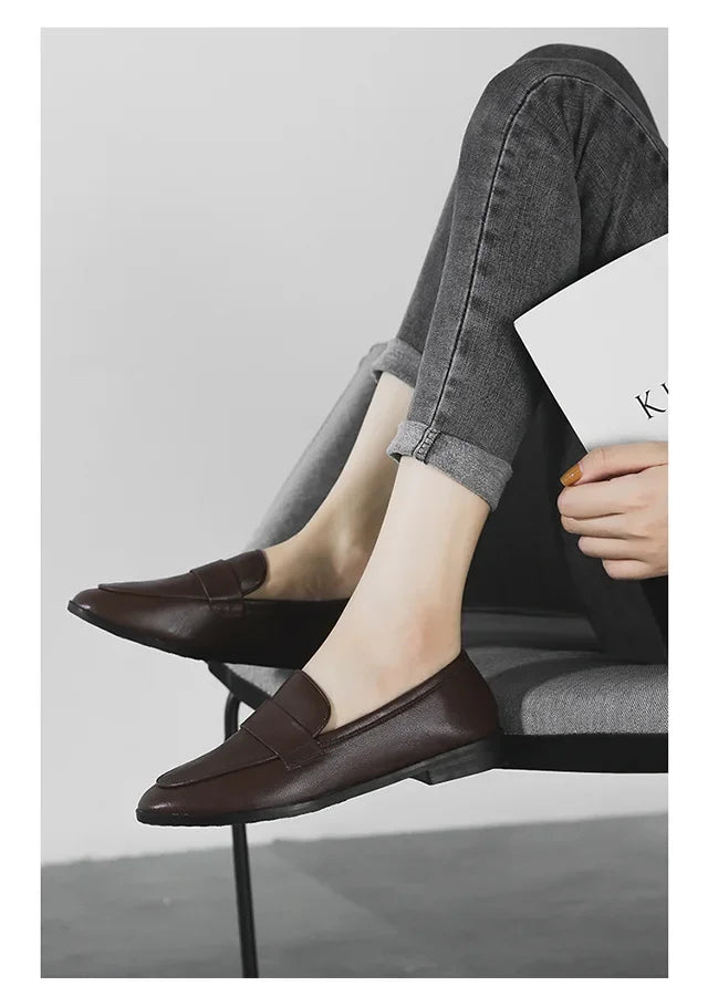 Women’s dark brown leather slip-on loafers, round toe, low flat sole.