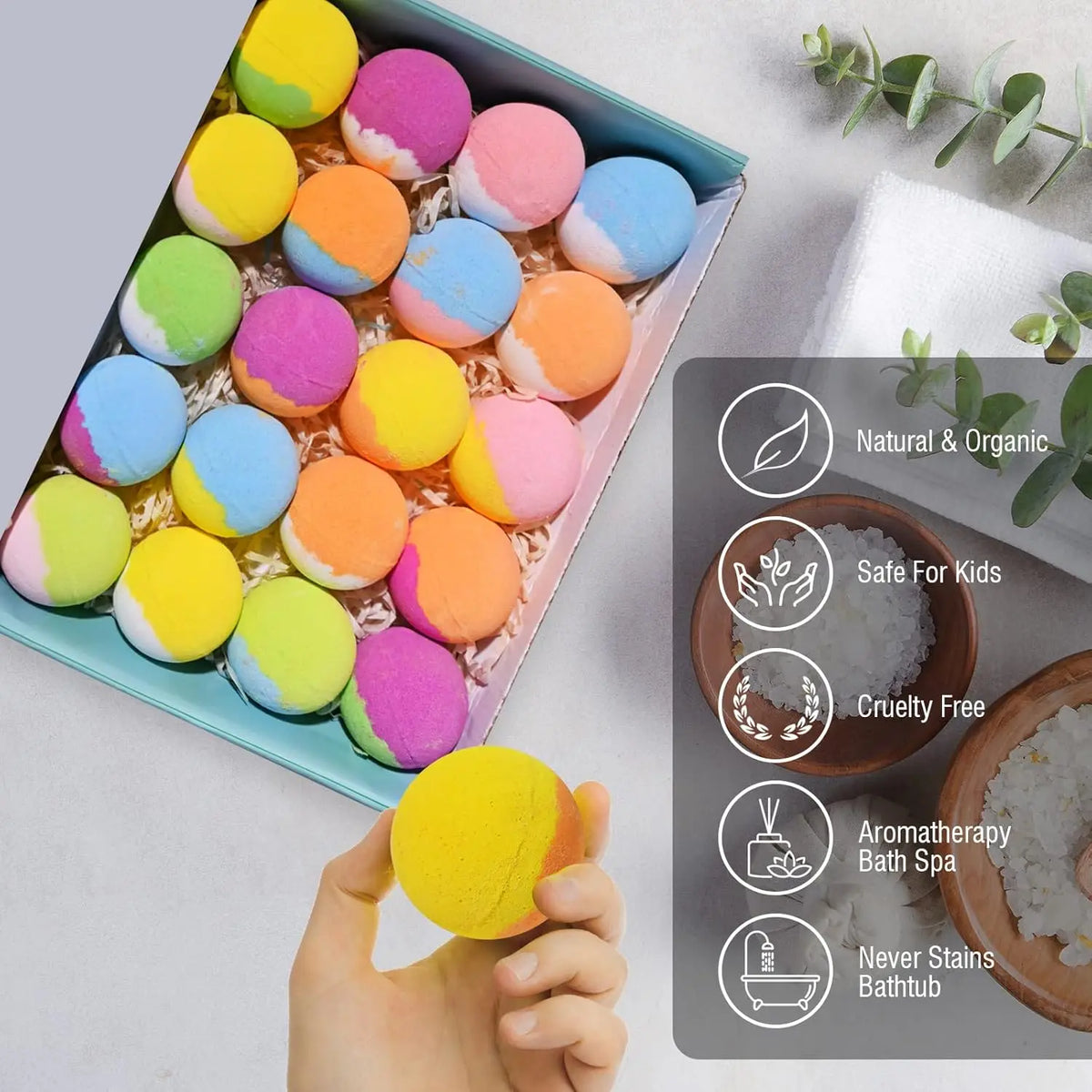 Open bath bomb gift box with multicolored round balls; one bath bomb held