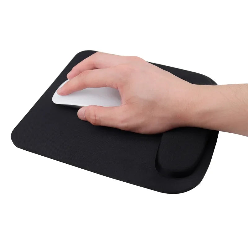 Black ergonomic mouse pad with wrist rest, shown being adjusted by hand
