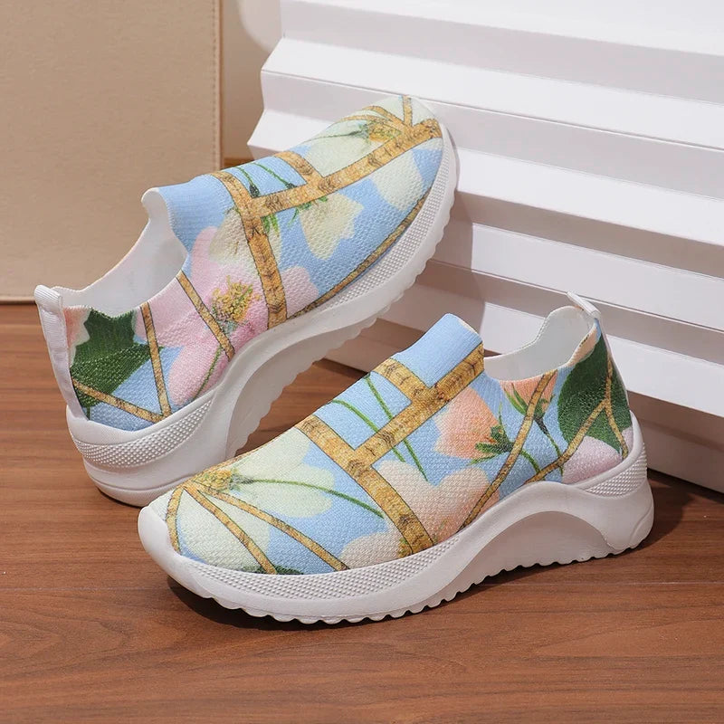 Pair of multicolor slip-on platform sneakers with cross gold straps and cushioned white soles