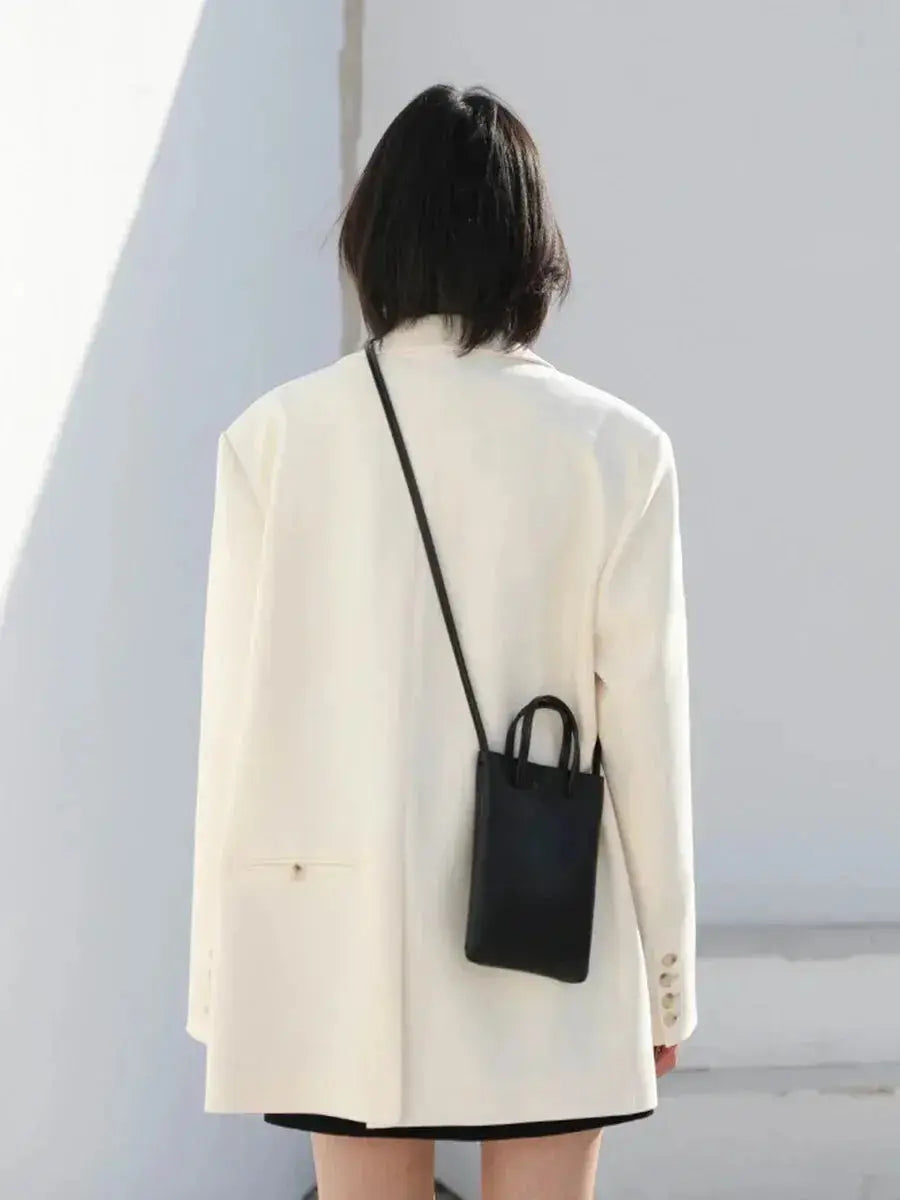 Ivory solid long-sleeve coat back view with center seam and cuff buttons
