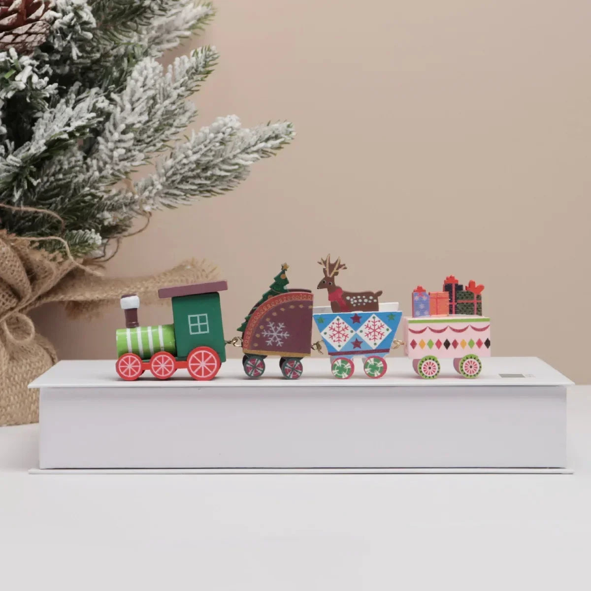 Painted wooden Christmas train set with reindeer and ornaments on multicolor cars