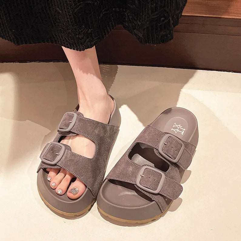 Gray suede platform slide sandals with two adjustable buckle straps