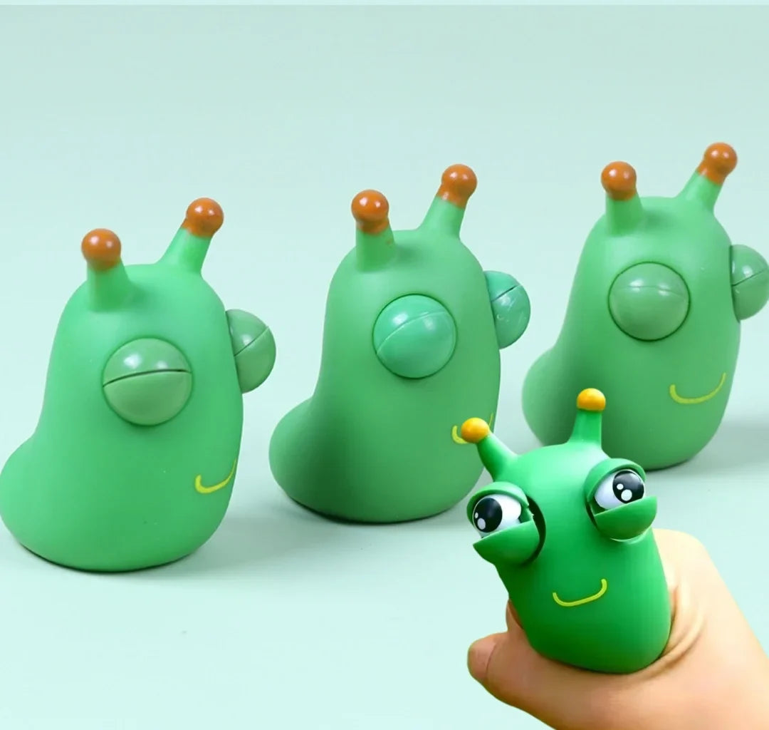Green worm squeeze fidget toy set with pop-out eyes and smile face