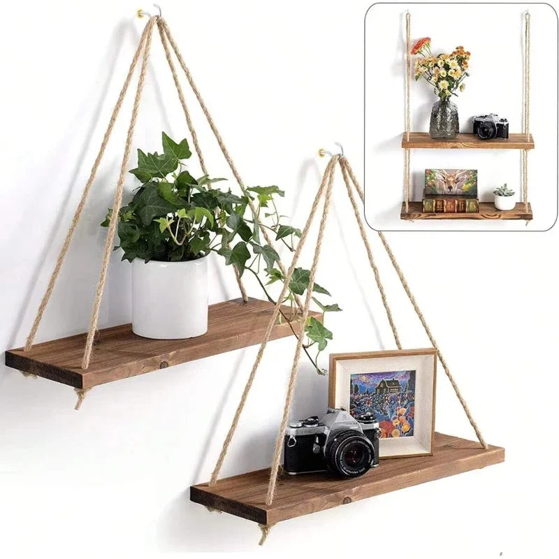 Two triangular hanging wooden shelves with hemp rope, holding plants, camera, and decor