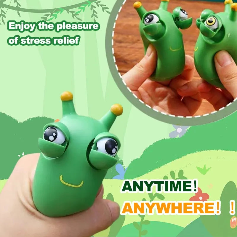 Green worm squeeze fidget toy pair, pinched in a hand with big eyes
