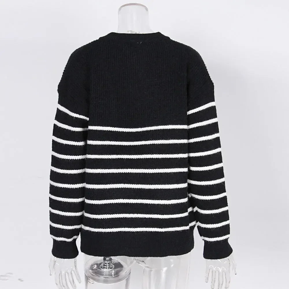 Women's black O-neck knit sweater, back view with white horizontal stripes, long sleeves