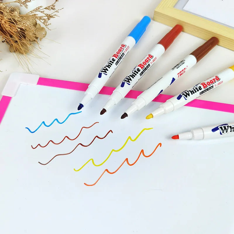 Water floating ink pens with white barrels and colored tips, arranged for drawing