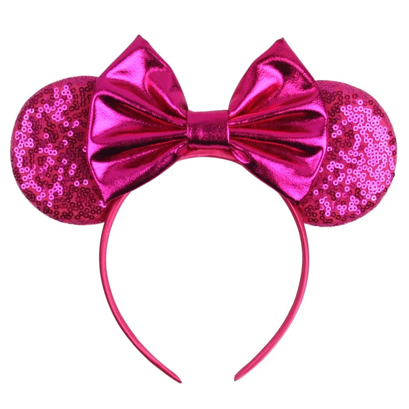 Hot pink sequin Mickey-style ears headband with shiny pink bow and curved band.