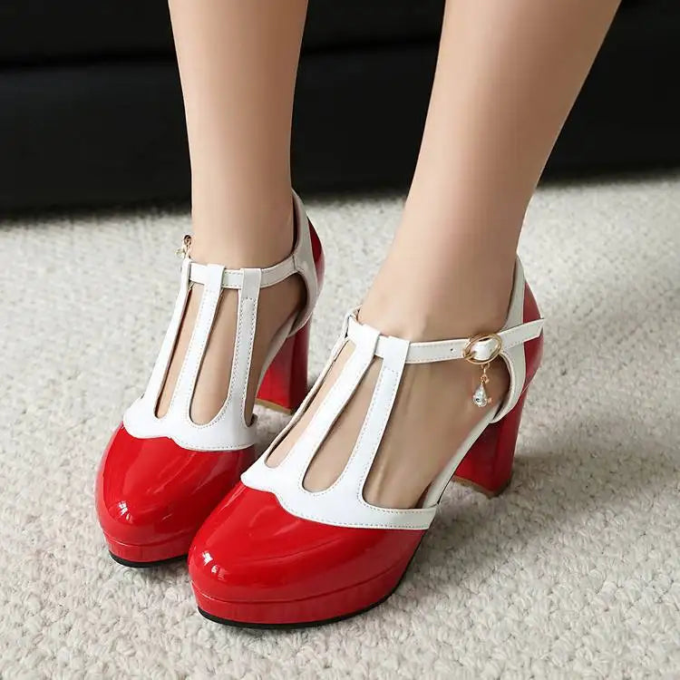 Pair of red-and-white T-strap heels with round toe and square block heel.