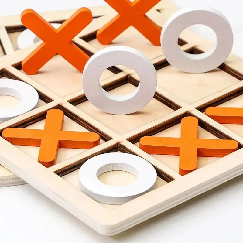 Wooden tic-tac-toe board close-up with orange X pieces and white O rings