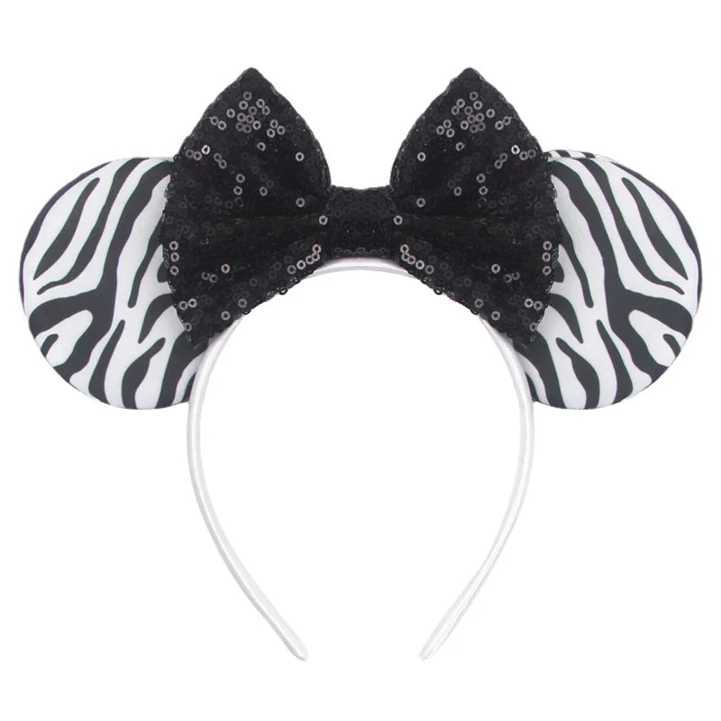 Zebra-print ear accents with black sequin Mickey-style headband and curved band.