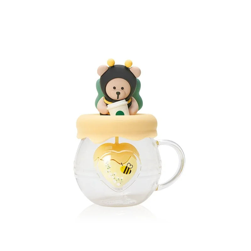 Glass tea infuser mug with bear character topper and bee decal on the mug