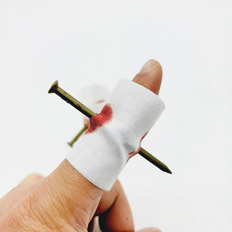 Handheld prank spring toy with white bandage wrap and pointed metal ends