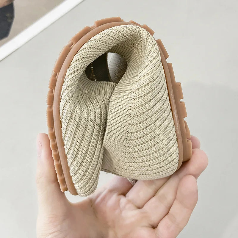 Women's cream knit slip-on flats close-up, textured sole, cushioned fit