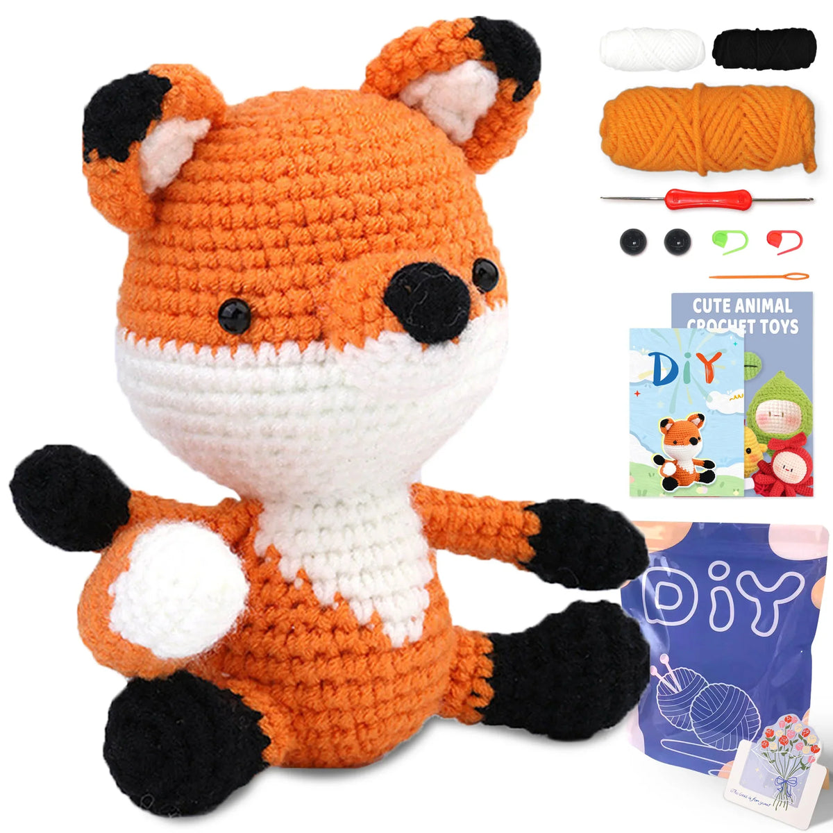 Crochet animal toy kit with orange fox plush, black details, yarn balls, and hook