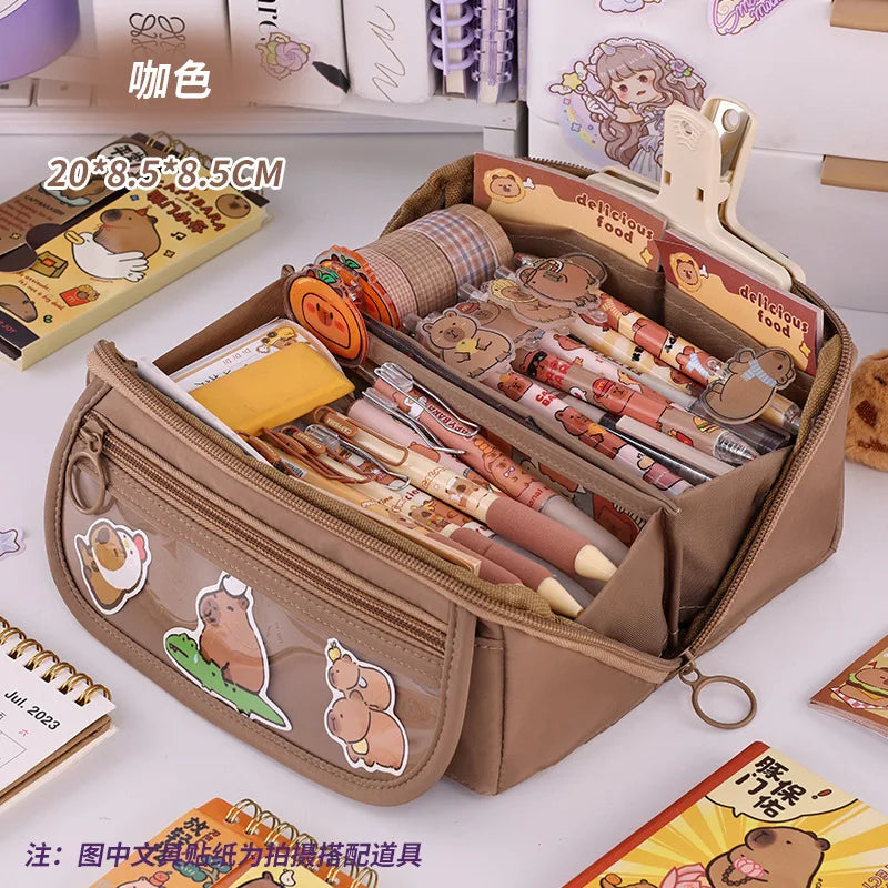 Brown zip pencil case open with pens and organizer sections, front animal patch