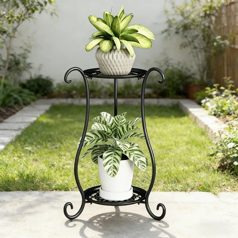 Black two-tier outdoor plant stand with ornate scroll legs and round display base