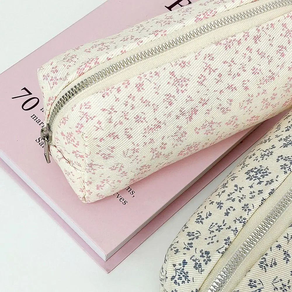 Two large canvas pencil pouches with zippers: cream red floral and cream navy floral