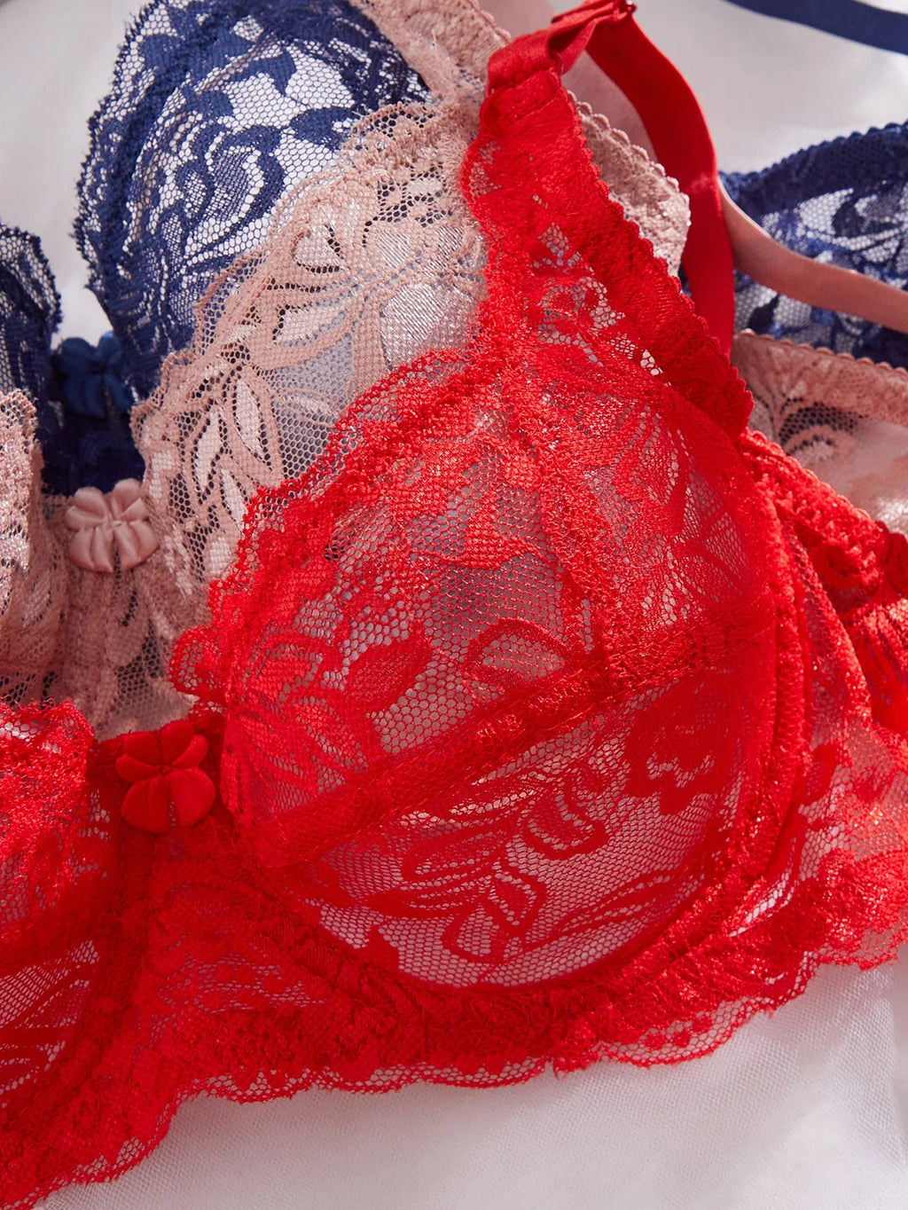 Red lace underwire push-up bra cup with floral texture and scalloped trim