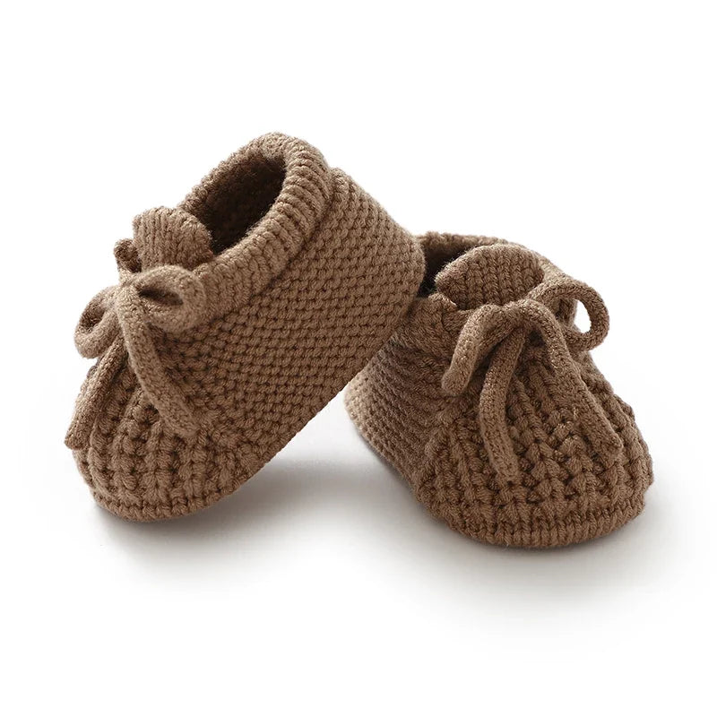 Tan-brown knitted baby booties with soft lining and tie lace bows